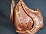 brown leather purse on a black background with a black background