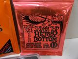 a close up of a bag of guitar strings next to a package of strings