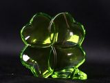 a close up of a green glass flower on a black background