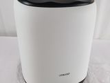 a white and black air purifier sitting on top of a plastic bag