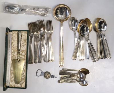 a lot of silverware on a table with a case