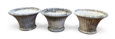 trois vases posés l'un à côté de l'autre sur une surface blanche