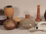 many different types of vases sitting on a table