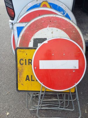 many signs that are sitting on the side of the road