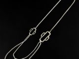 a silver chain with a clasp on a black background