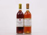 two bottles of wine sitting next to each other on a table