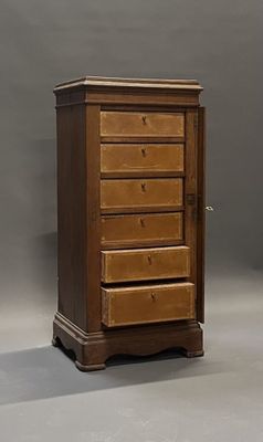 a wooden chest of drawers sitting on a gray floor