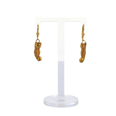 a close up of a pair of earrings on a stand