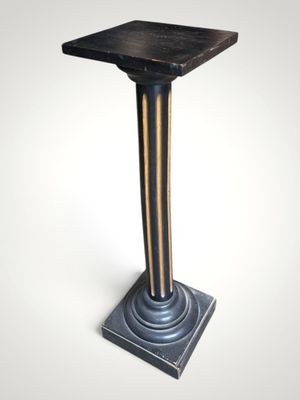 an image of a black and gold pedestal with a wooden top