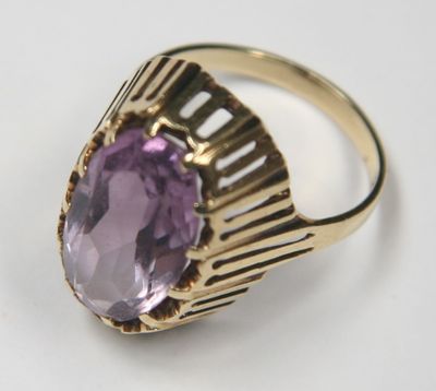 an image of a gold ring with a large amethorate stone