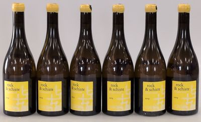 six bottles of wine are lined up on a table