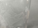 a glass with a picture of a man and a woman on it