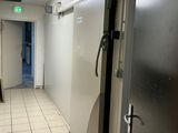 a white tiled floor in a room with a refrigerator and a door