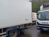 two trucks parked next to each other in a parking lot