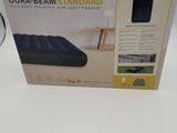 an inflatable mattress with a box on a white surface