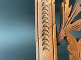 a close up of a carved wood frame with a bird on it