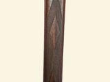 a close up of a wooden stick with a metal handle