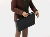 a figurine of a man with a briefcase in his hand