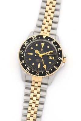 a close up of a wrist watch on a white surface