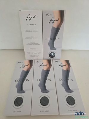 four pairs of socks in a box on a table