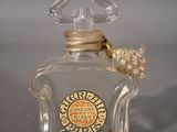 a small glass bottle with a rope around it