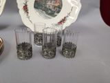 several glasses and a plate are sitting on a table