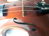 a close up of a violin that is on a table