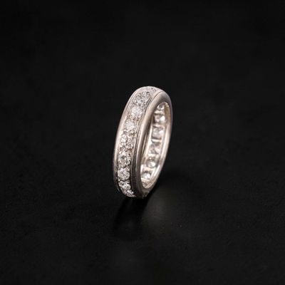 a close up of a diamond ring on a black surface
