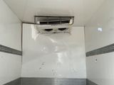 a small air conditioner in the corner of a room