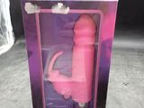 packaging of a pink sex toy in a plastic box on a table