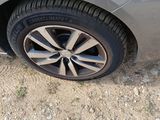 a close up of a car ' s tire on a dirt road
