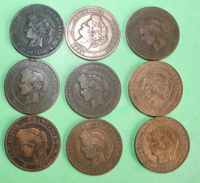 six different types of british coins on a green surface