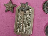 a lot of medals and medals on a pink cloth