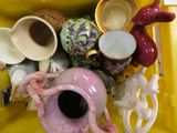 a yellow container filled with different types of vases