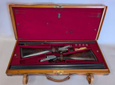 a wooden case with two guns inside of it