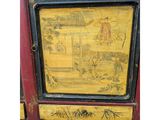 yellow and black painted cabinet with oriental scenes on the door