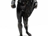 statue of a man holding a cloth on a wooden base