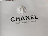 a white bag with the logo of chanel on it