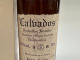 a bottle of alcohol sitting next to a box