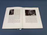 un livre ouvert sur lequel figure l'image d'un groupe de personnes assises sur un banc