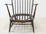 an image of a wooden chair in a white room