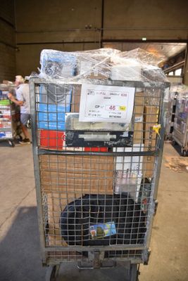 a cart with a lot of items in it in a warehouse