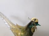 a glass bird that is sitting on top of a table