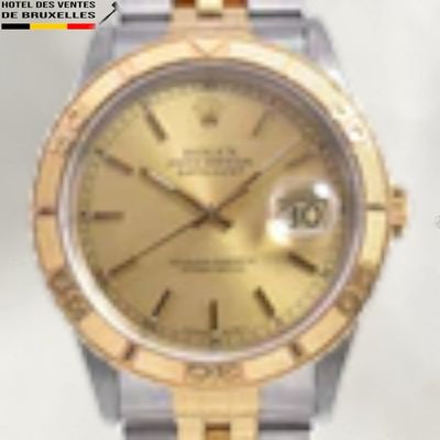 a watch with a gold dial on a silver and gold bracelet