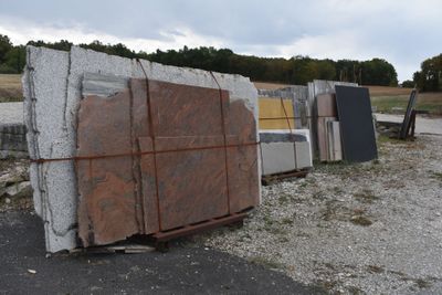 a pile of granite blocks sitting on the side of the road