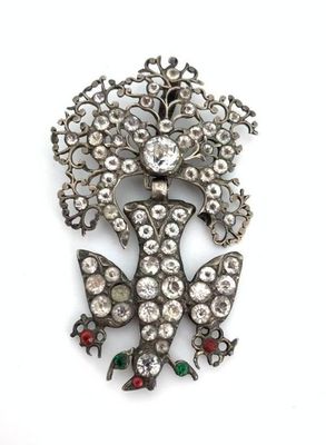an image of a brooch with a bunch of flowers on it
