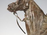 a bronze statue of a horse with a harness on