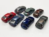 several toy cars are lined up in a row on a white surface