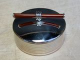 a silver box with a pair of chopsticks on it
