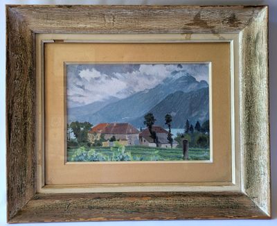 framed picture of a painting of a house in a field with mountains in the background